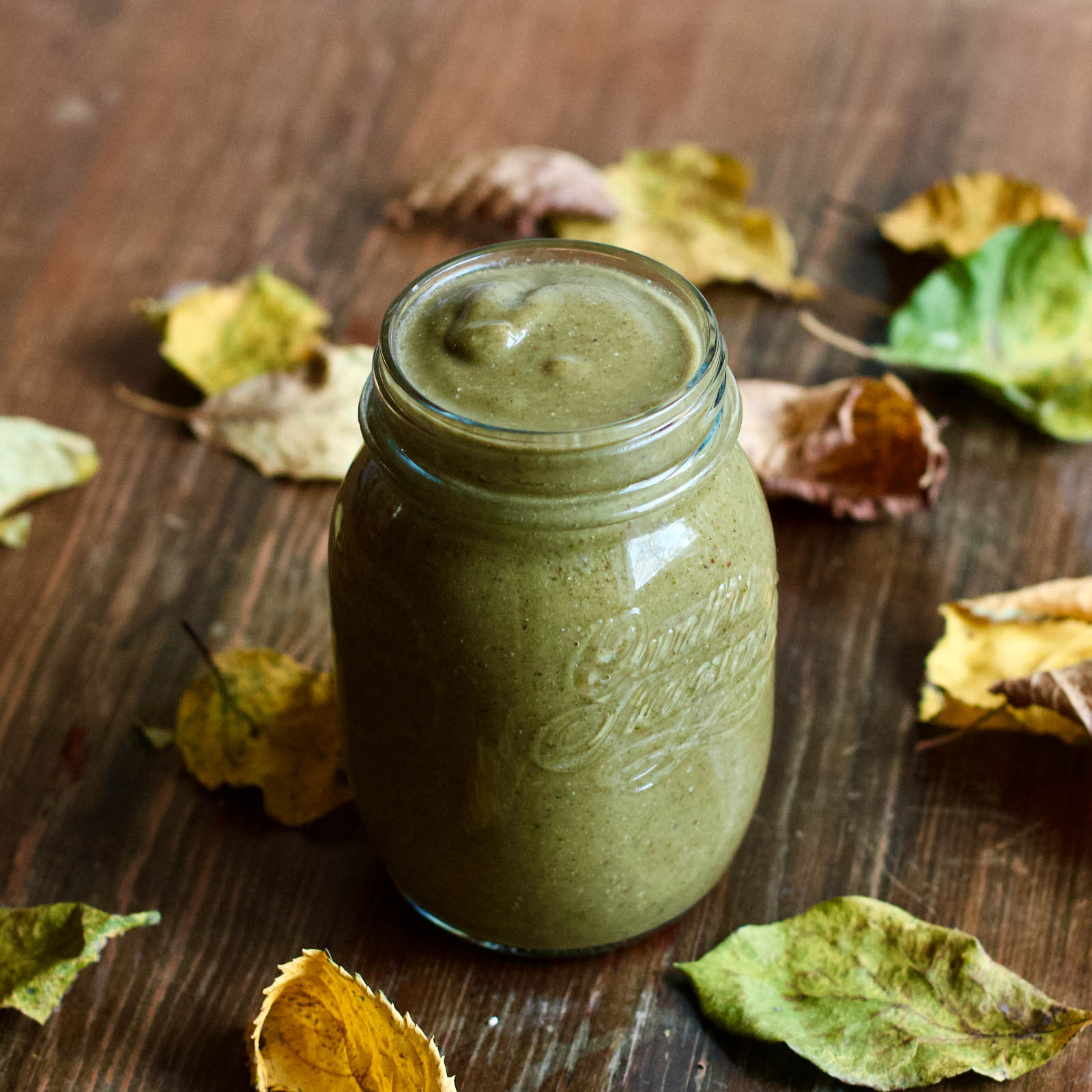 Autumn Love Green Smoothie in glass jar on a wooden table