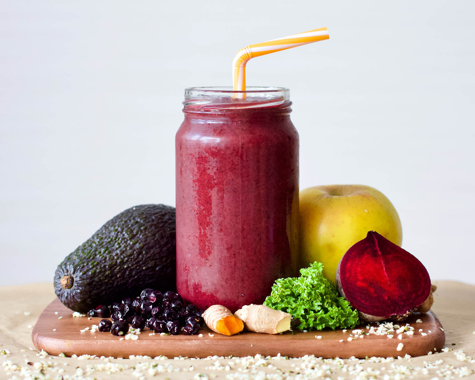 One serving of Berries and Red Beet Spicy Smoothie, and lots of plants around it on a table