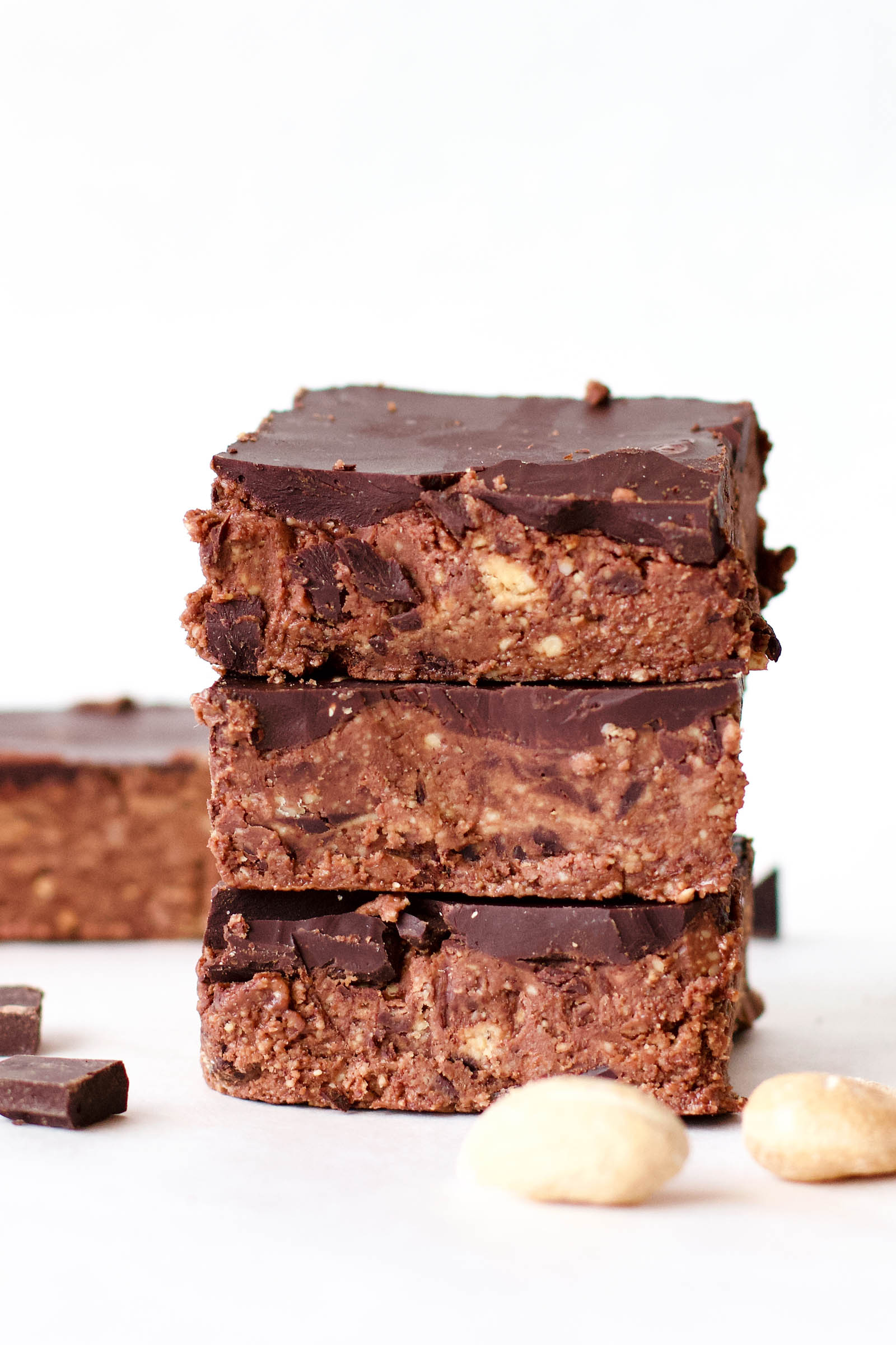 Close-up with stack of three Double Chocolate Cashew Raw Fudge and another one in the background
