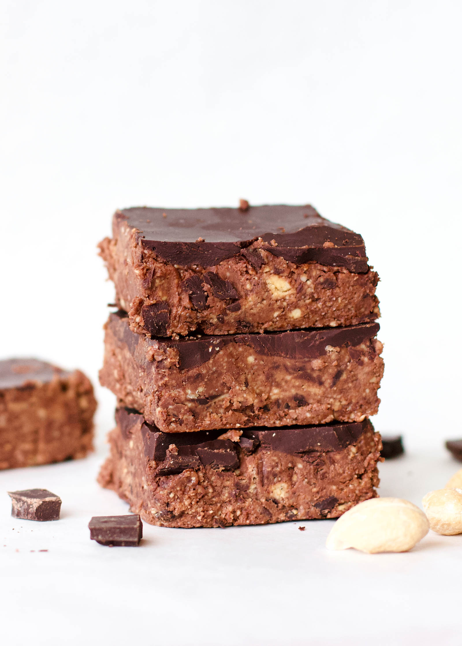Close-up with stack of three Double Chocolate Cashew Raw Fudge on a white background