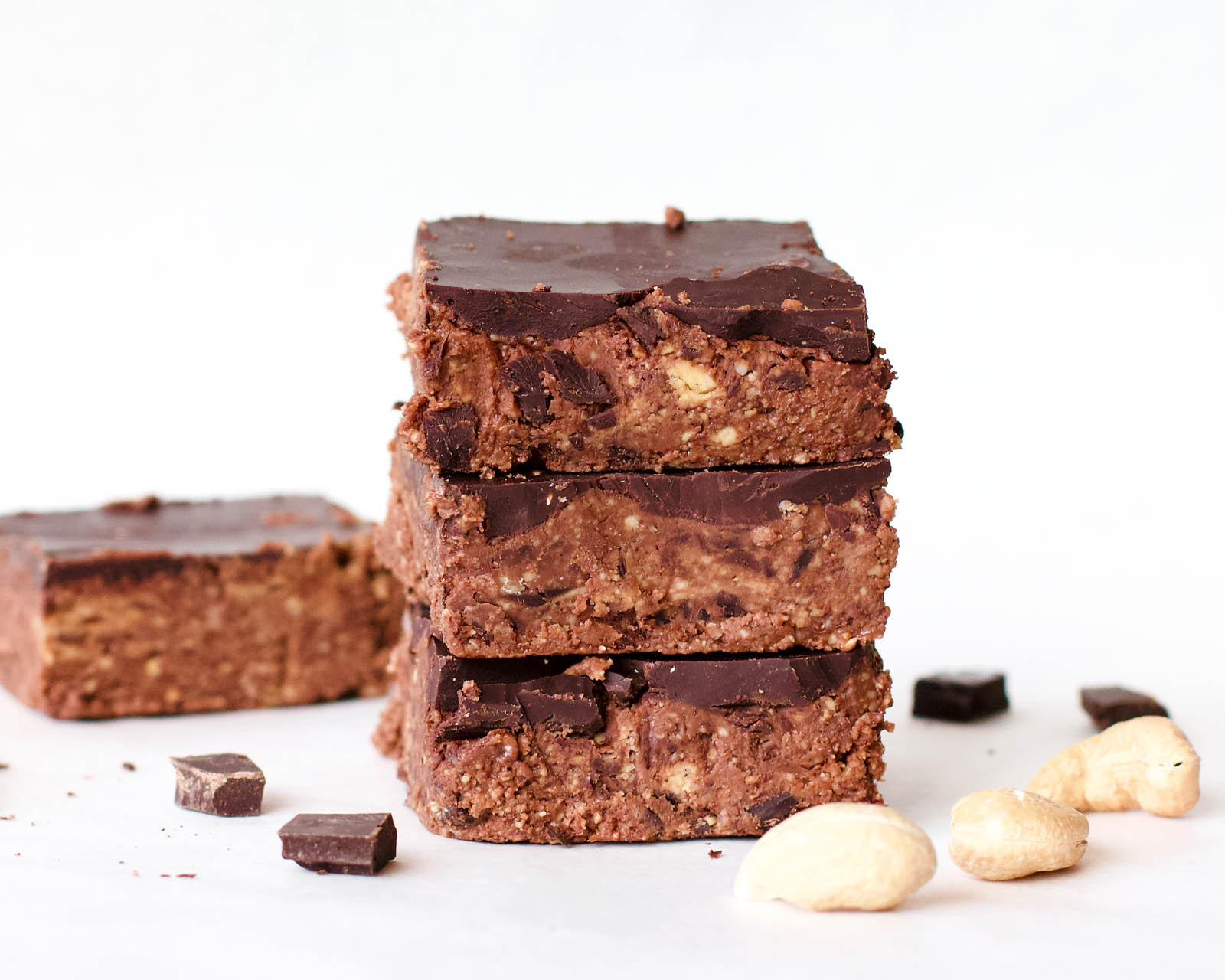 Stack of three Double Chocolate Cashew Raw Fudge and another one in the background