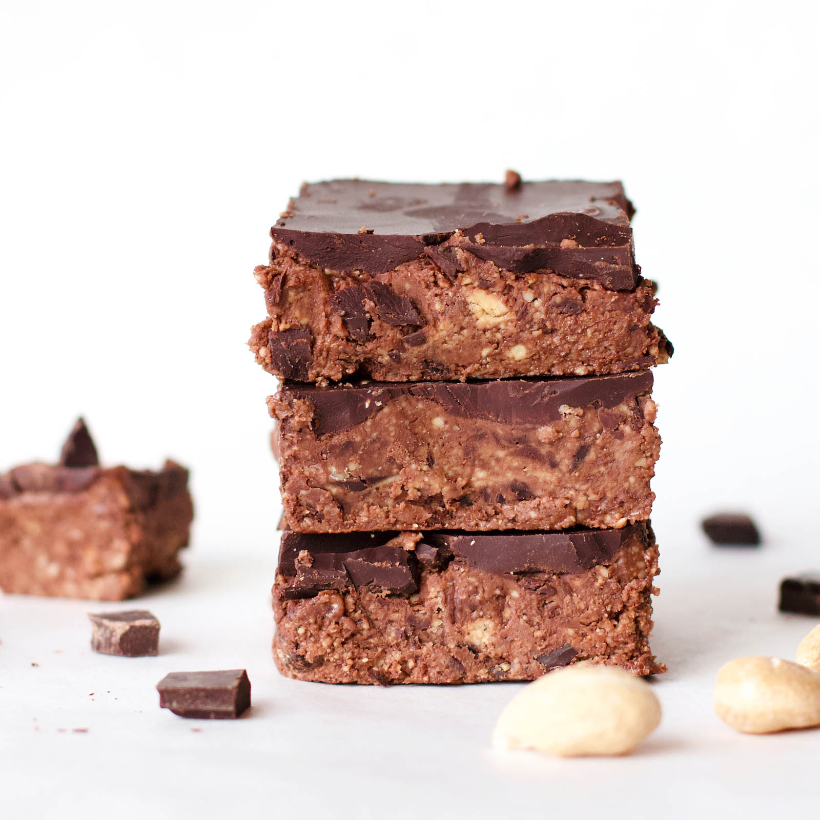 Close-up with stack of three Double Chocolate Cashew Raw Fudge on a white background