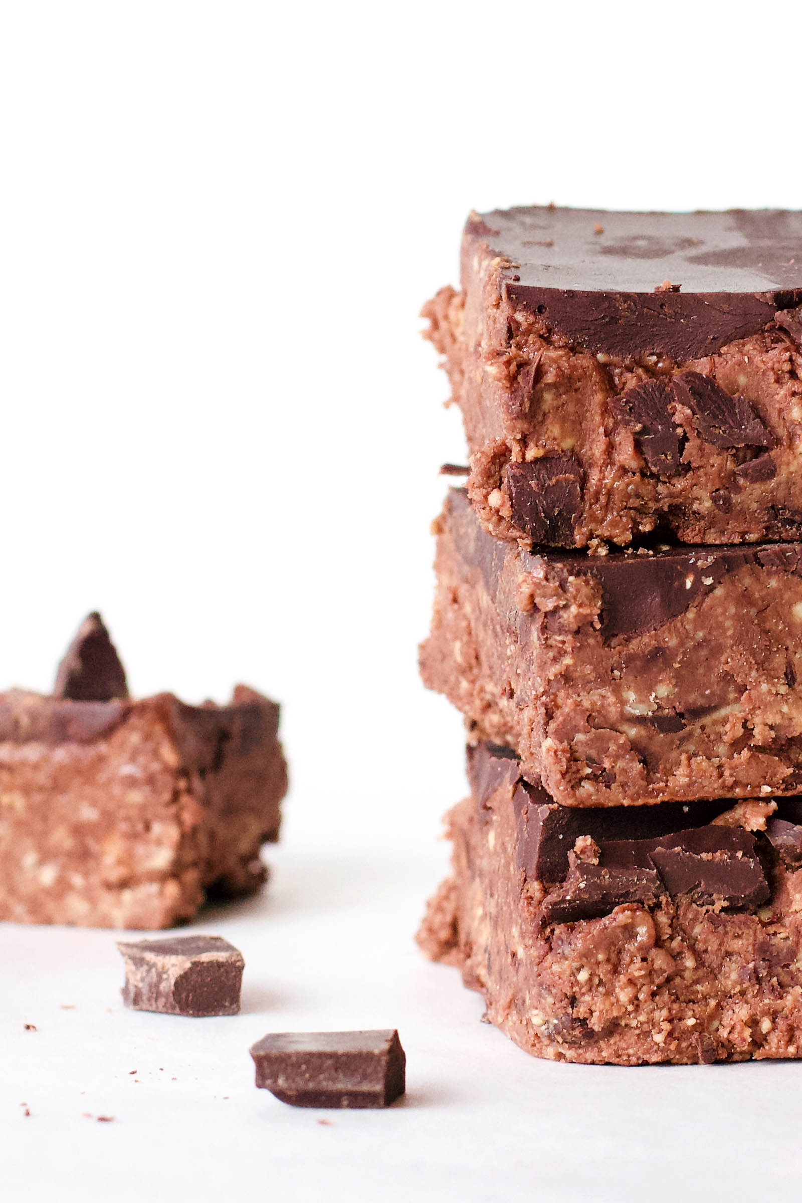 Close-up with stack of three Double Chocolate Cashew Raw Fudge on a white background