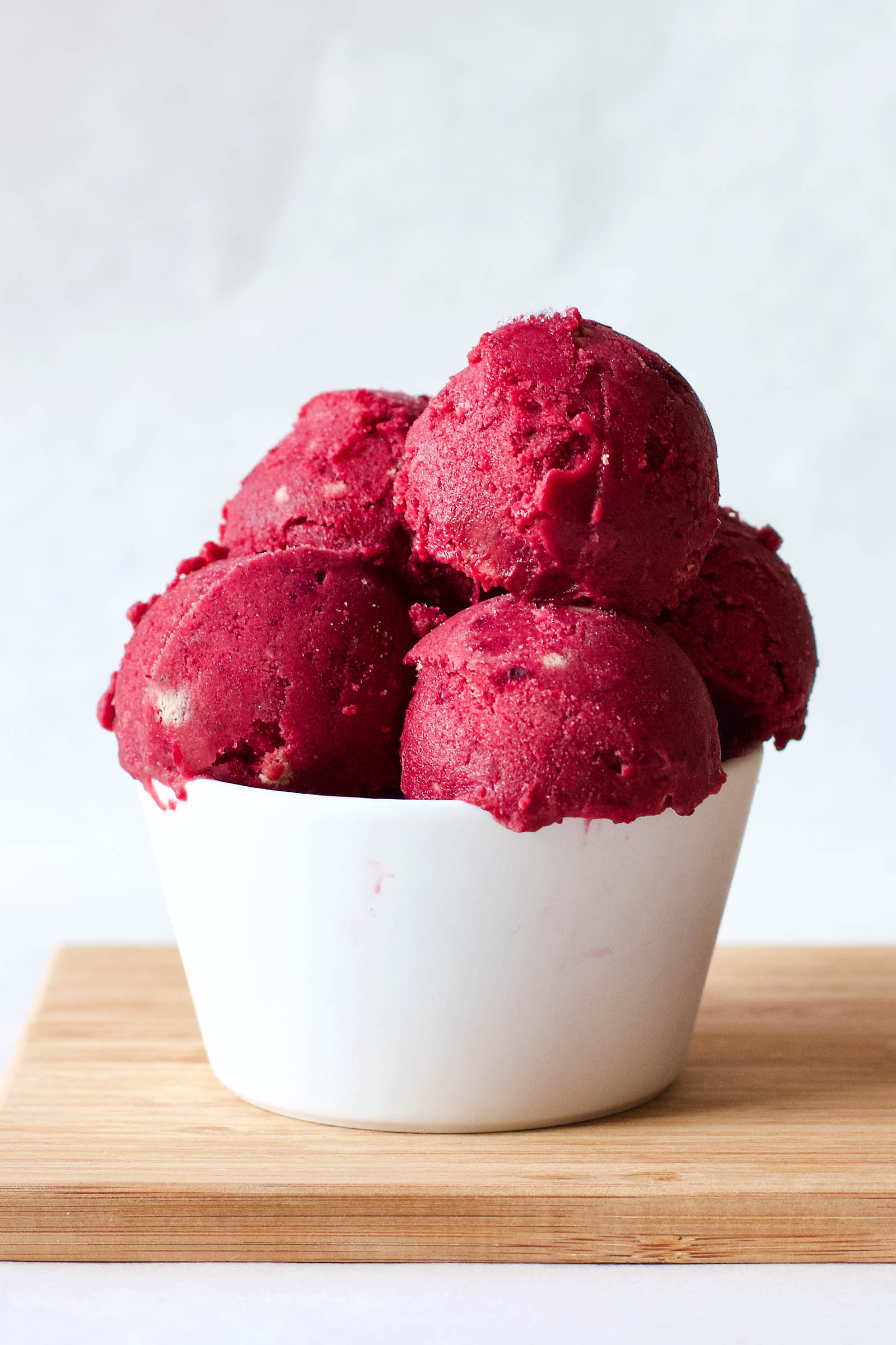 One serving of Red Beet Vegan Ice Cream on a wooden board