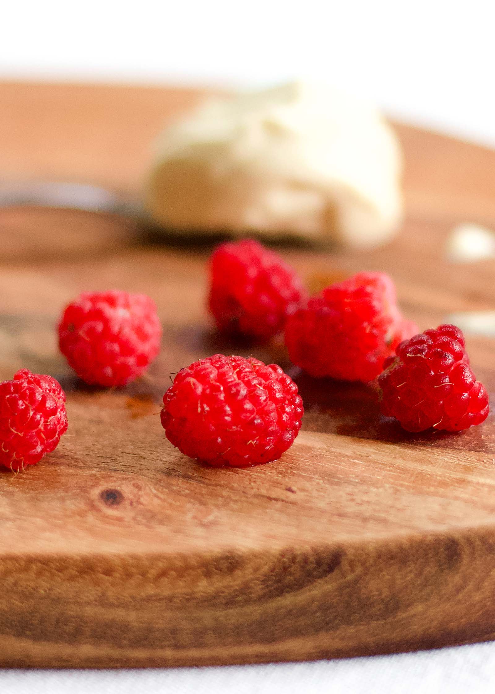 Close-up of fresh raspberries on a wooden board