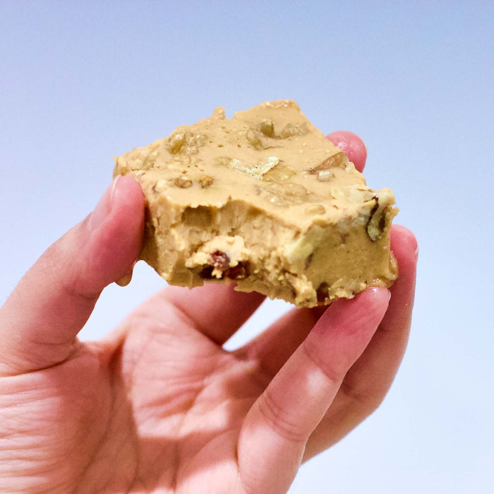 One serving of Delicious Cashew Butter Fat Bomb cookie bitten in, close-up