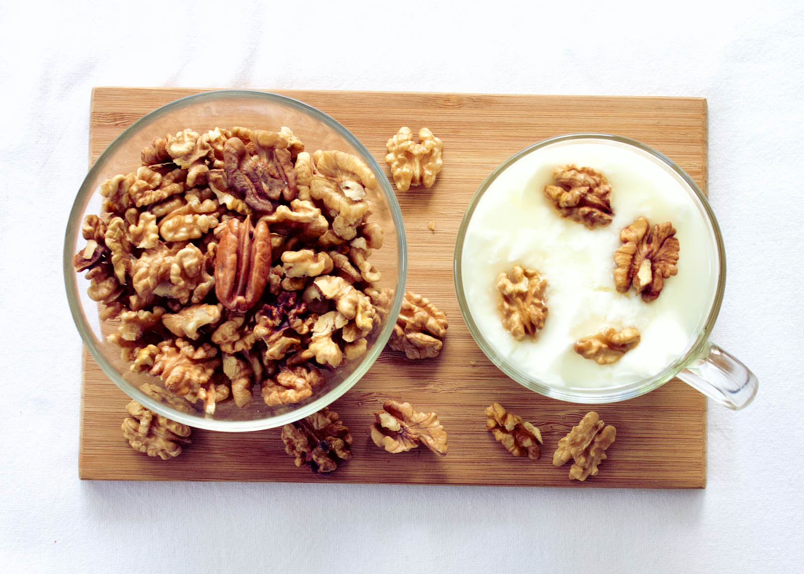 Big cup with Homemade Yogurt served with a miix of Walnuts and Pecans, top view