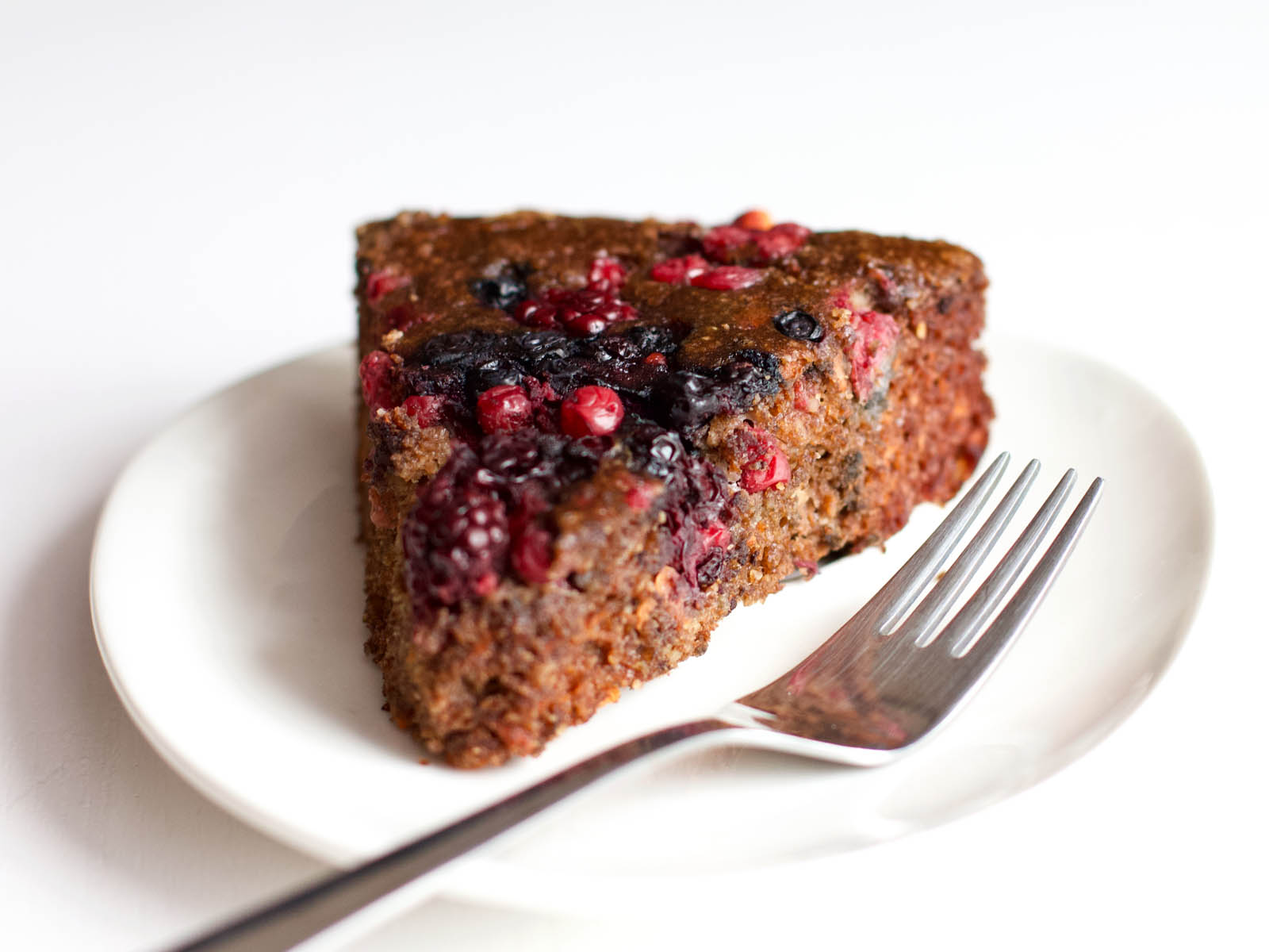 Single slice of Low-Carb Chocolate Cake with Berries on a plate, waiting to be served