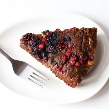 Single slice of Low-Carb Chocolate Cake with Berries on a plate and fork on the side.