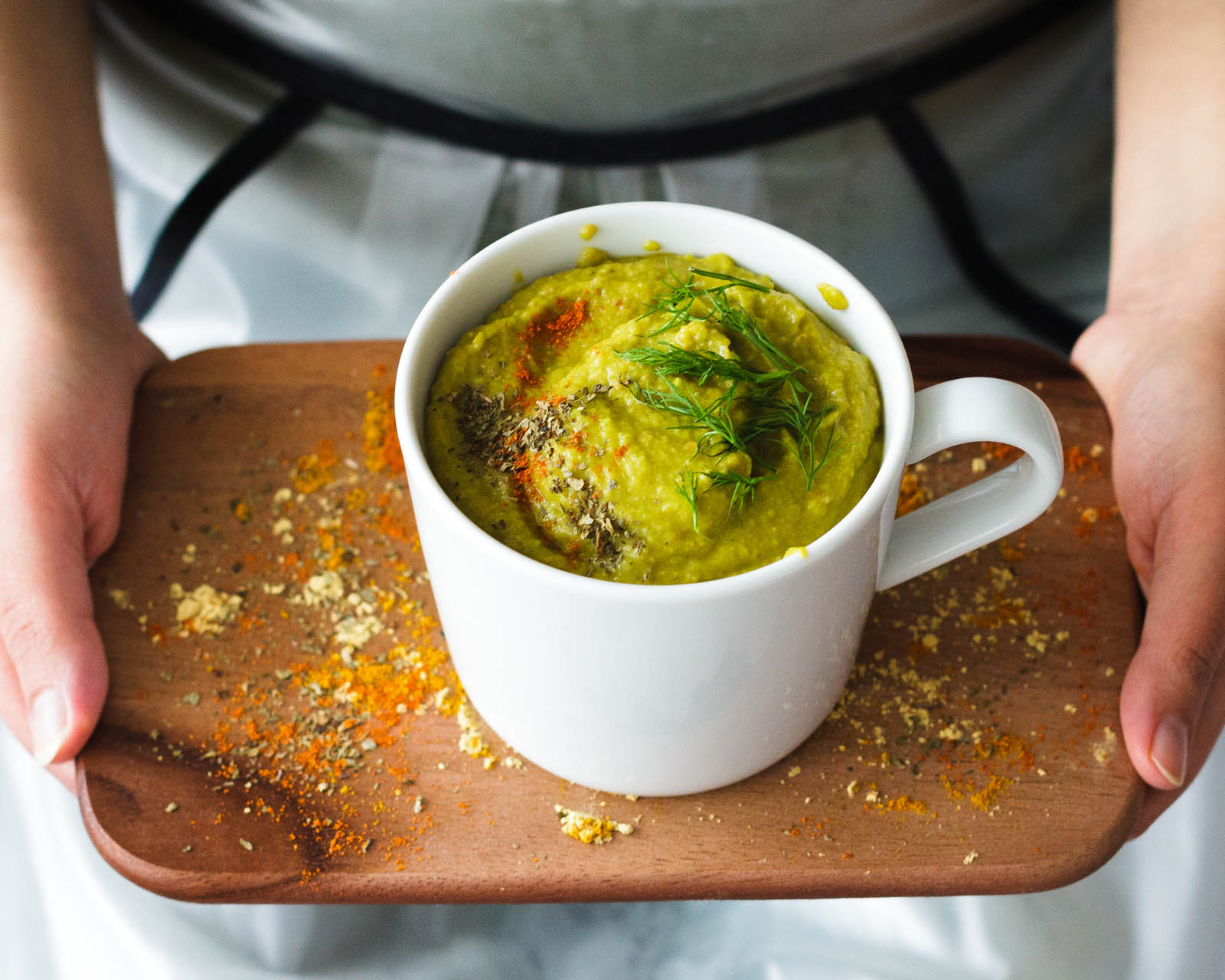 One serving of Porcini Mushrooms and Veggies Cream Soup on a wooden board, close-up presentation