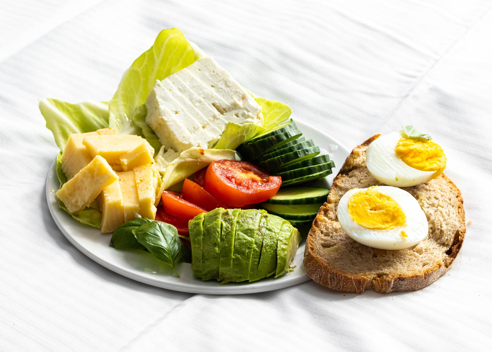 Quick Healthy Vegetarian Plate on a white background, side view close-up
