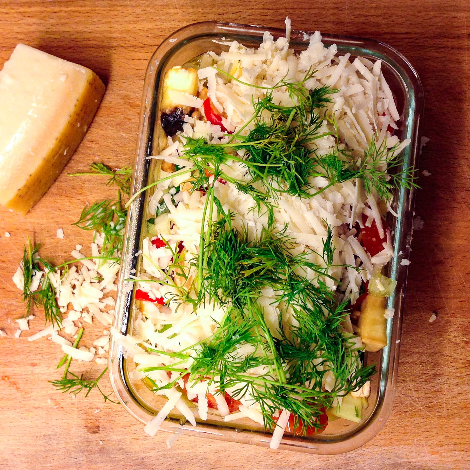 Progression shot with all the ingredients for my Frittata Cavolo recipe added to a glass tray, top-down view