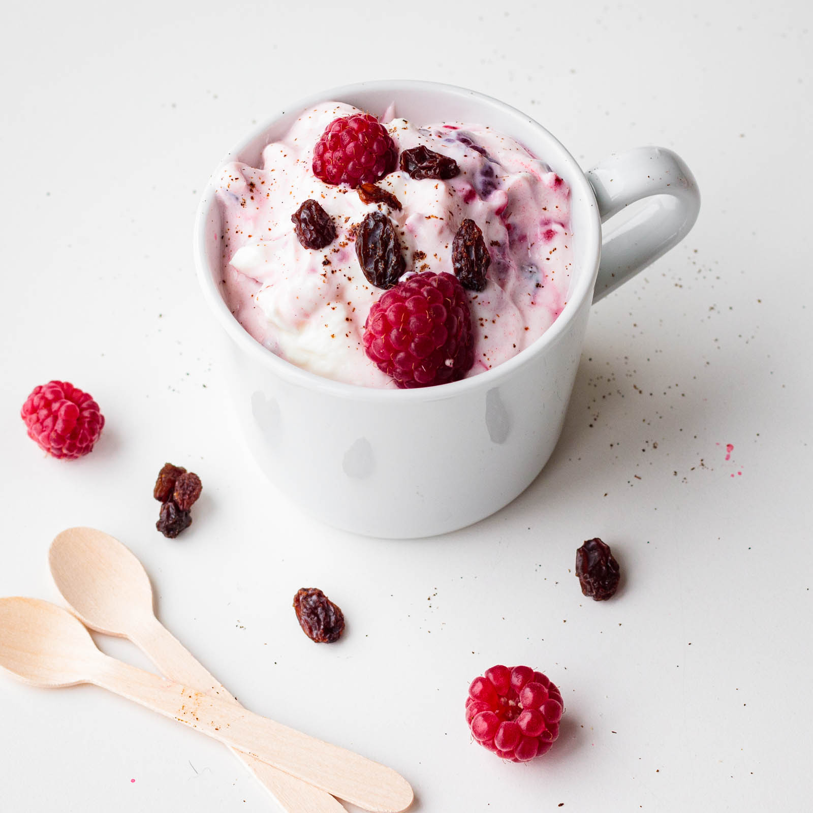 Delicious Norwegian Ice Cream decorated with raspberries and raisins, top view