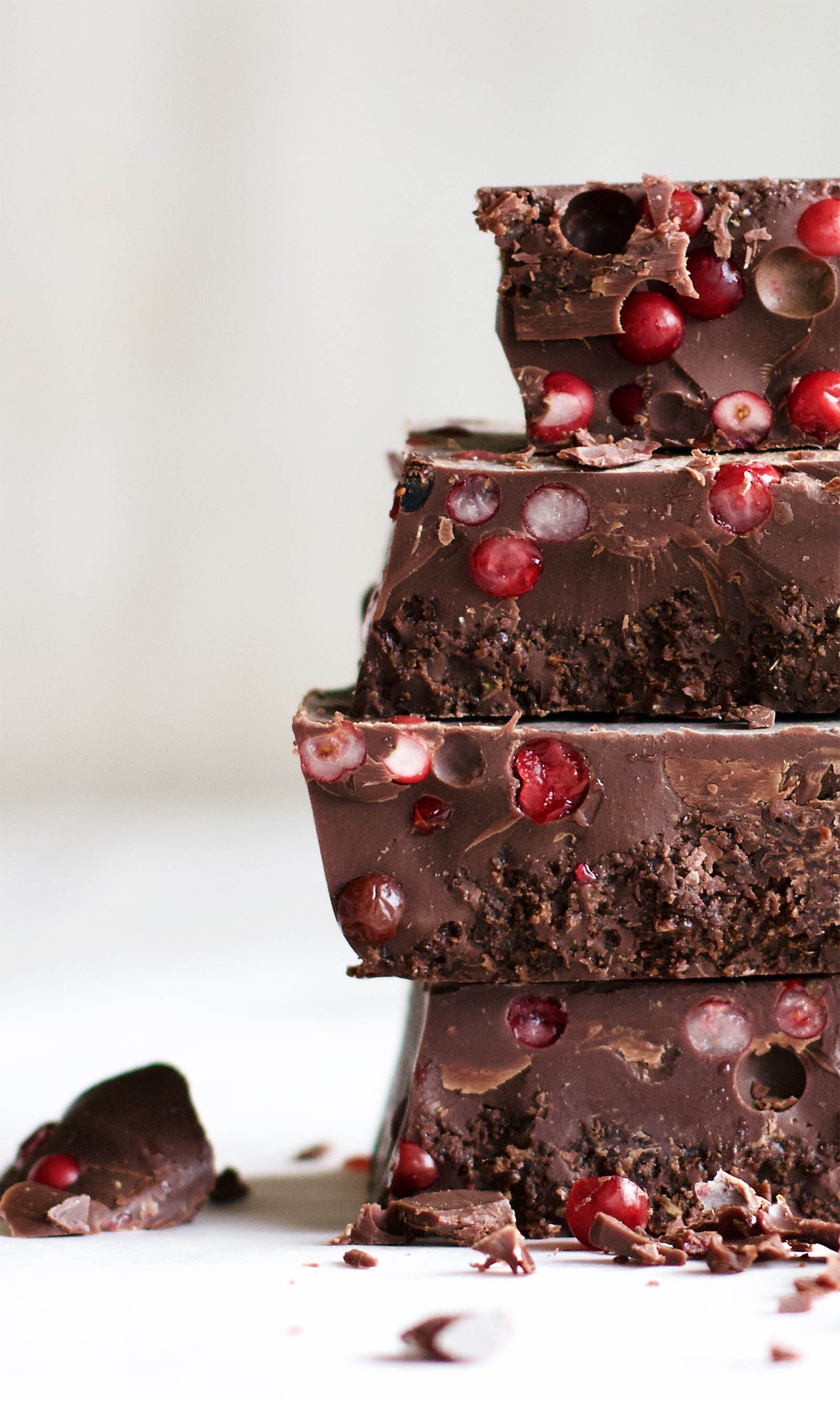 Close-up shot with stack of four Easy Keto Chocolate Fat Bombs with Cranberries, left side view