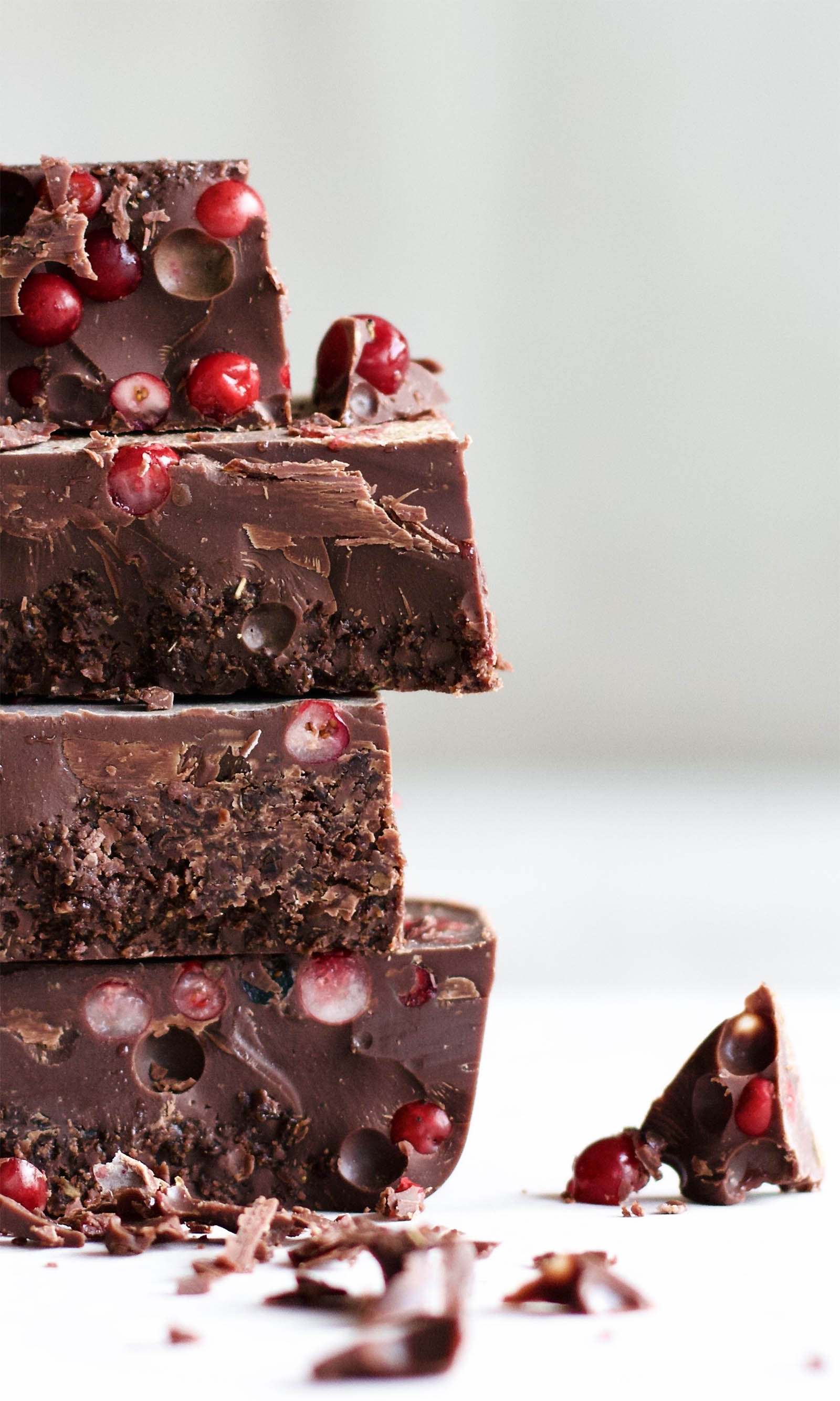Close-up shot with stack of four Easy Keto Chocolate Fat Bombs with Cranberries, right side view