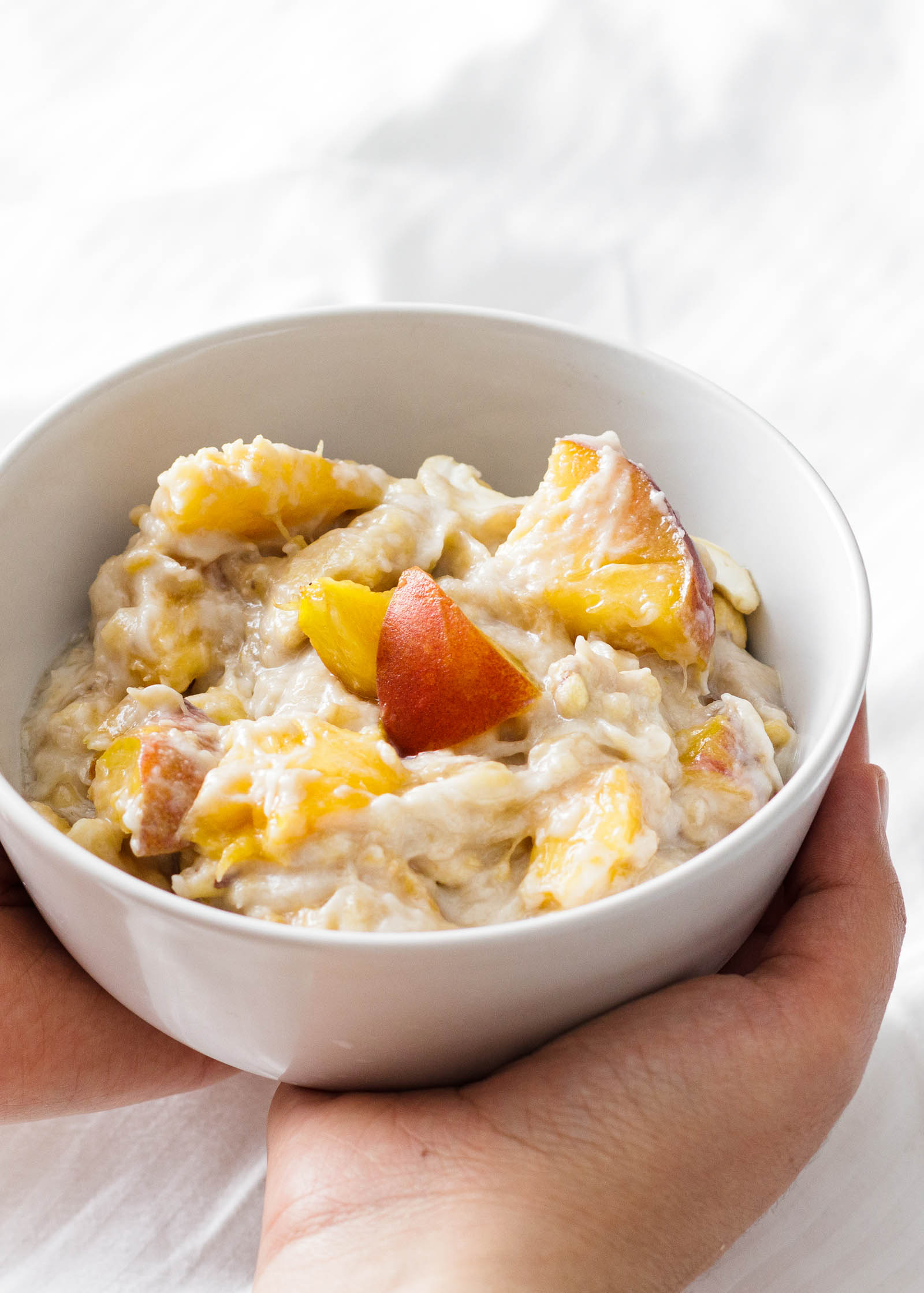 Bowl with freshly made 1-Minute Vegan Banana Coconut Pudding presented in hand