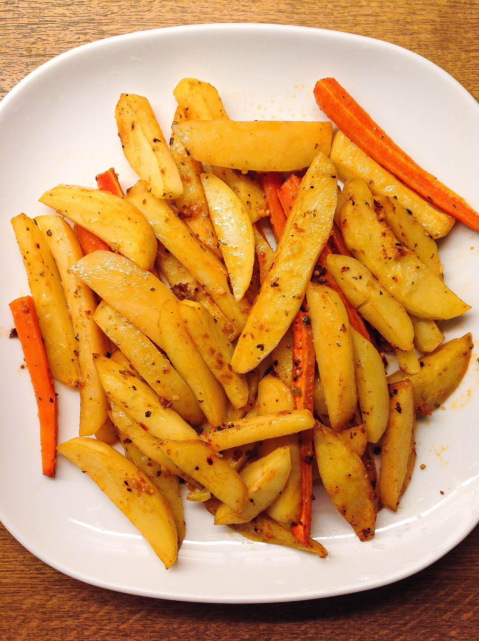 Top-down view with freshly made Easy Baked French Fries on a white plate