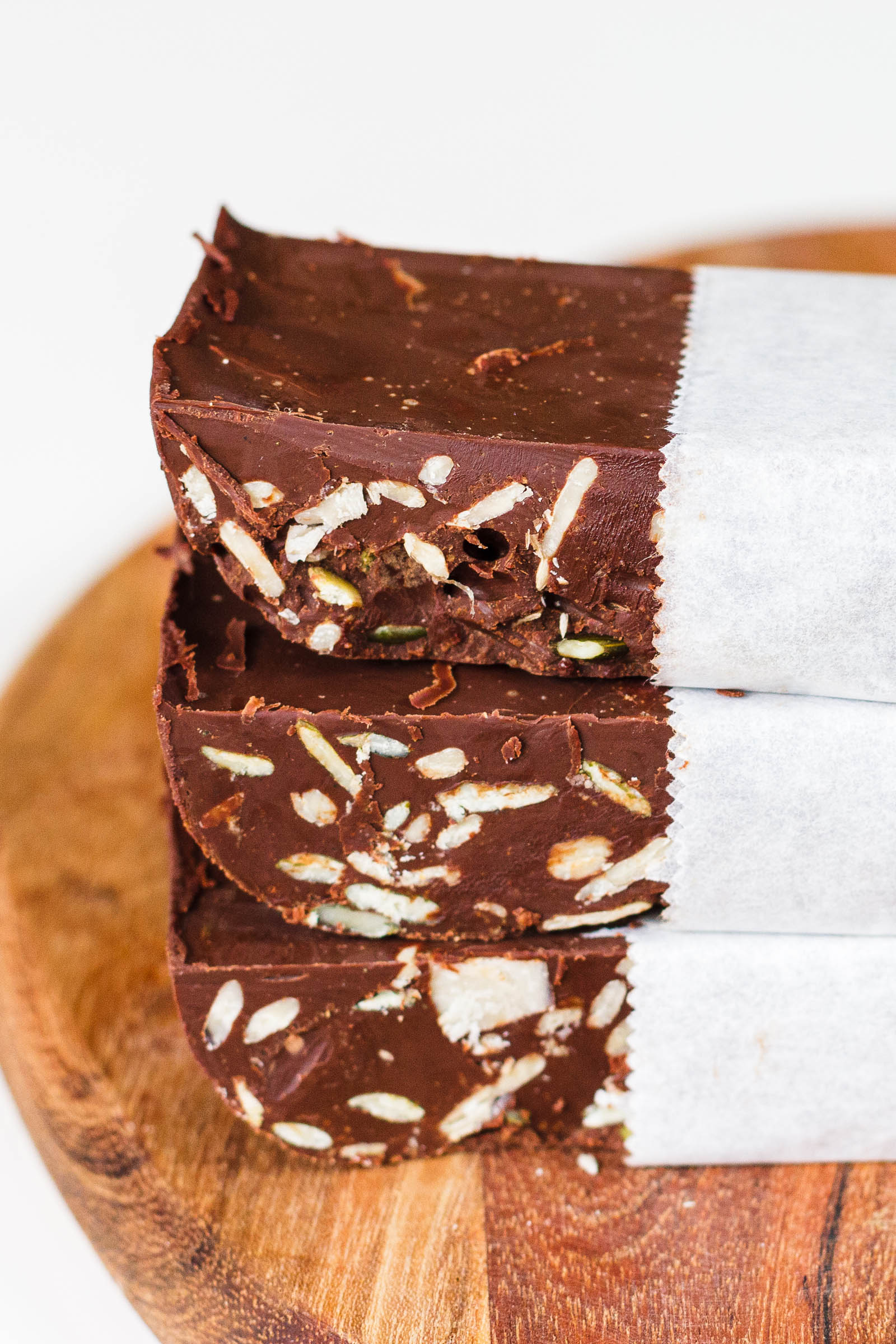 Stacked Vegan Dark Chocolate Nut Bars, close-up left side