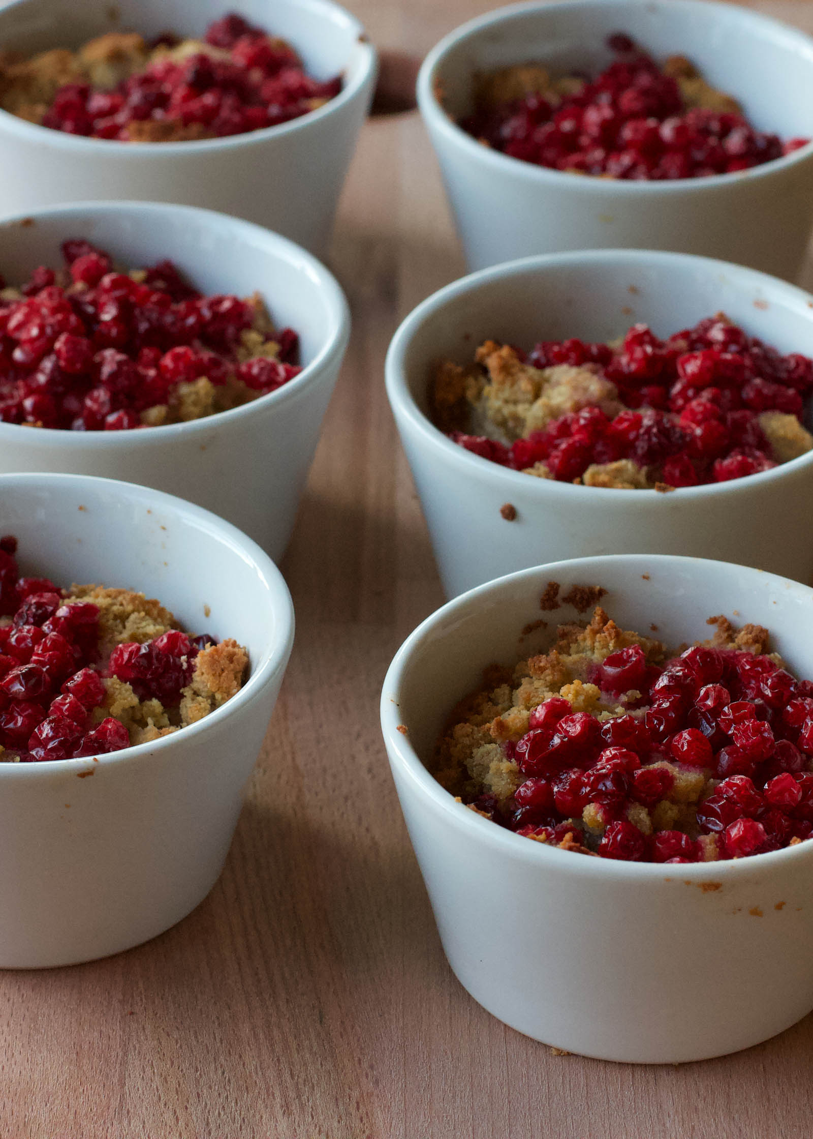 Six servings of Low-Carb Banana Coconut Mug Cake on a wooden board