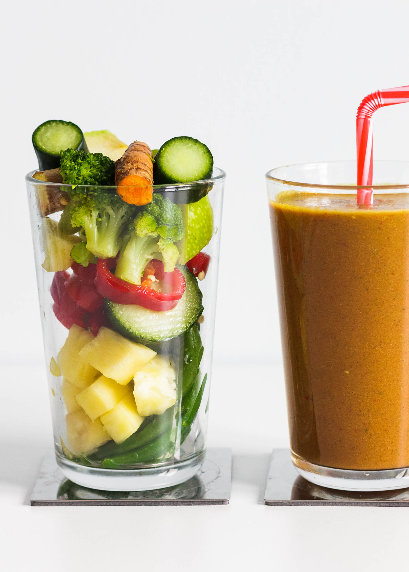 Glass with fresh plants, and another glass with freshly made Healthy Nutrient-Dense Breakfast Smoothie
