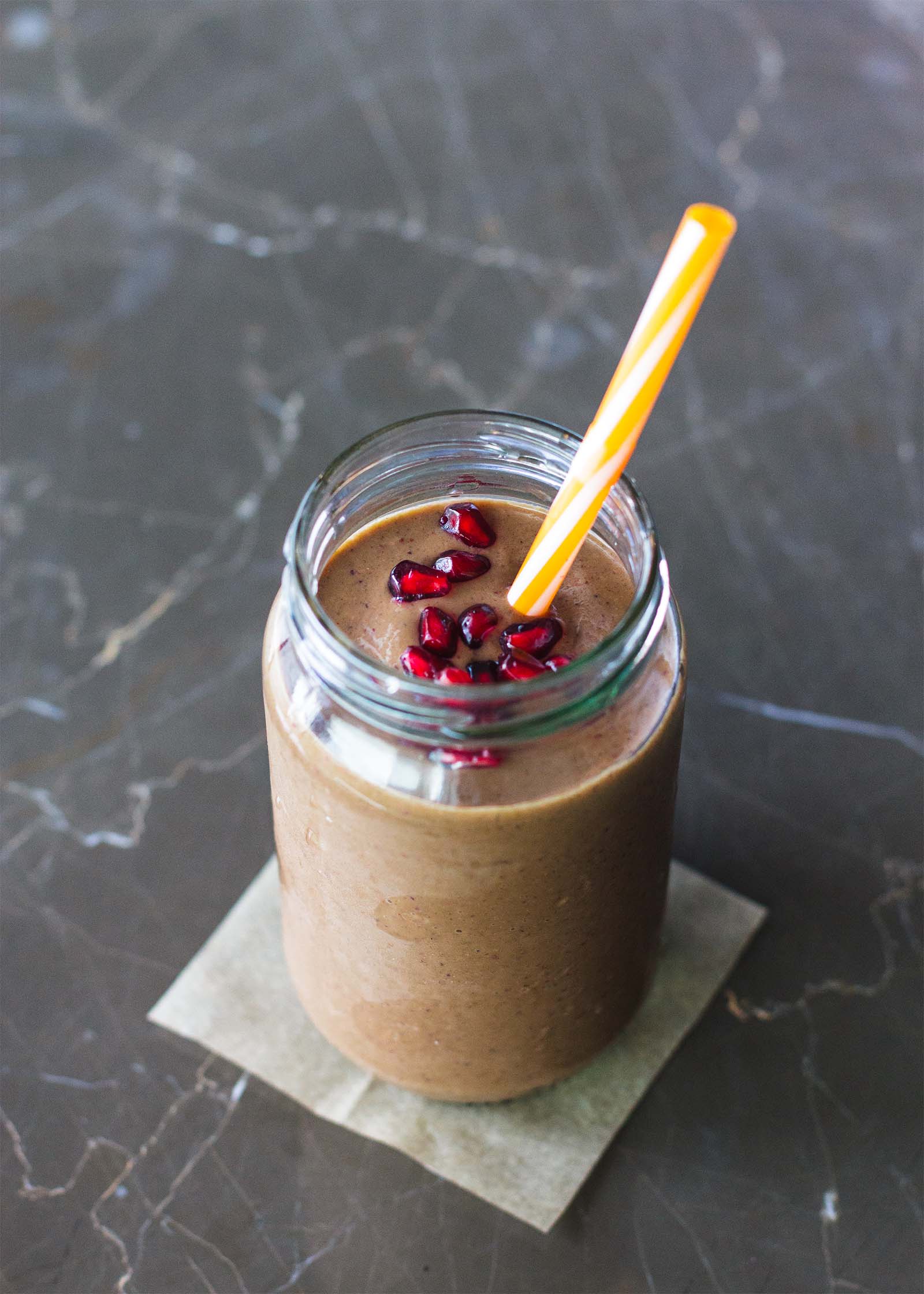 Jar with freshly made All-Day Energy Smoothie, and drinking straw inside