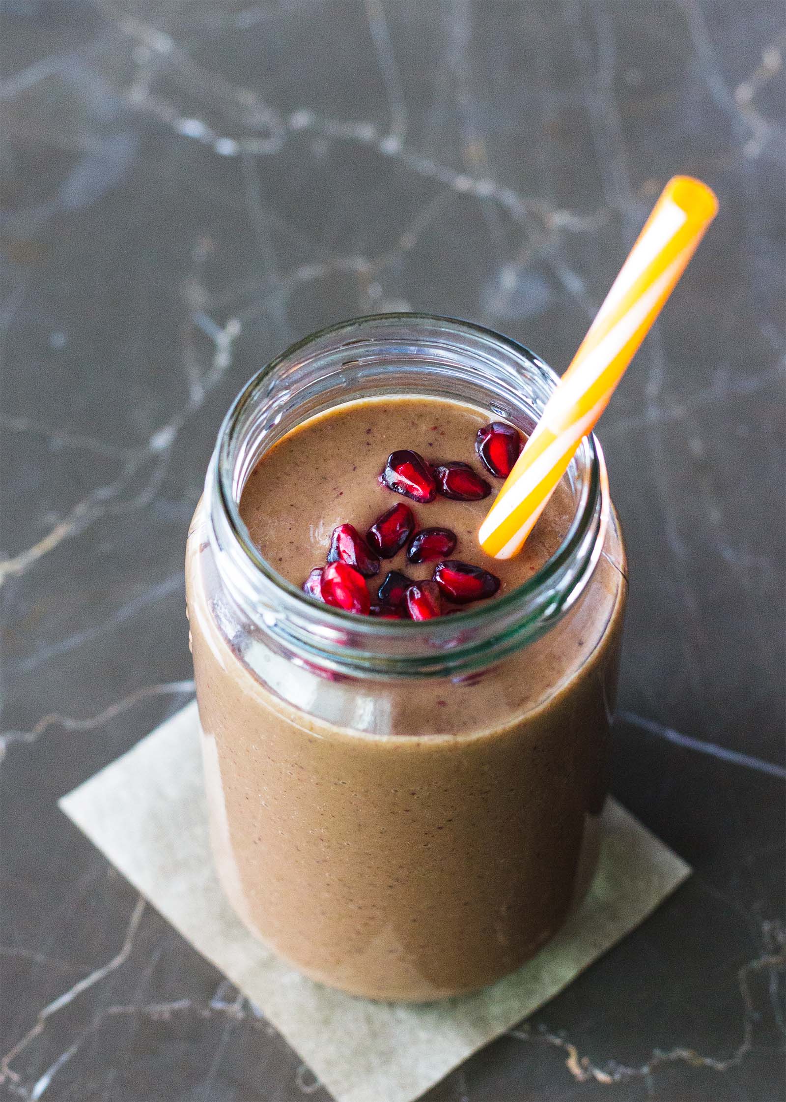 Jar with freshly made All-Day Energy Smoothie, and drinking straw inside