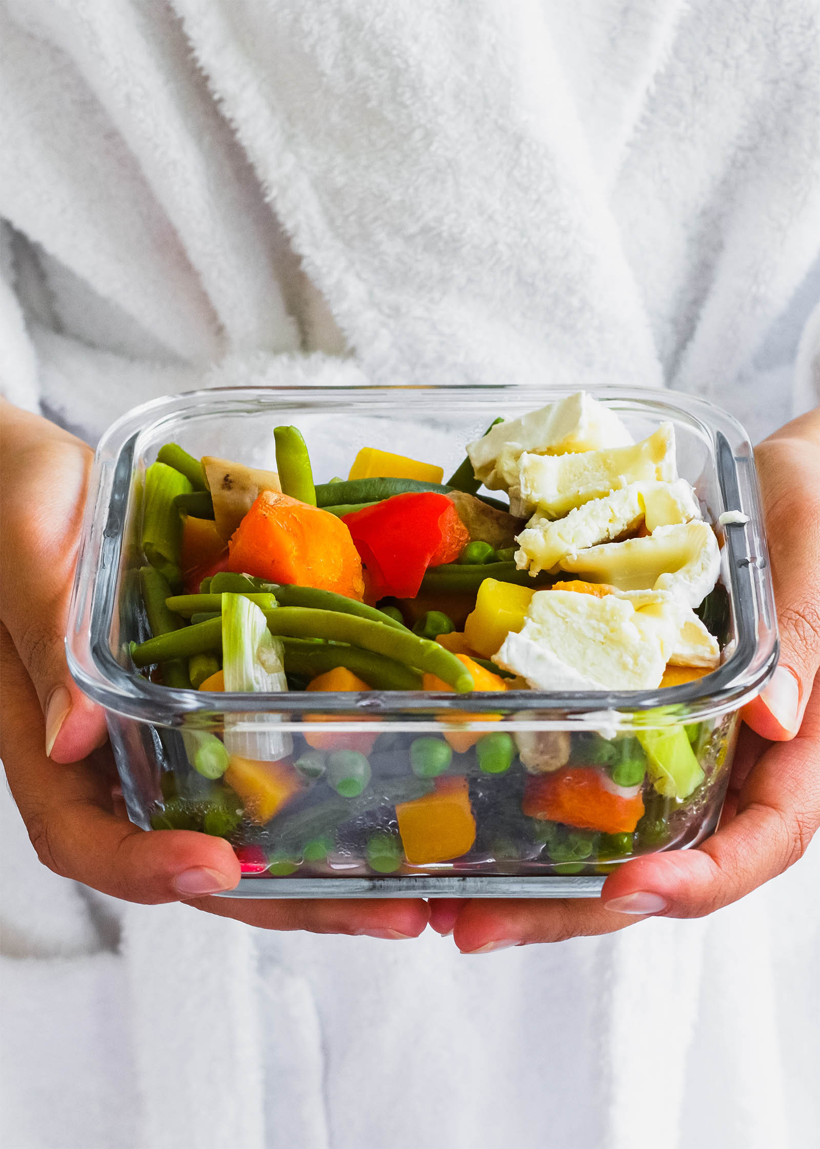 Glass tray with a serving of Salad with Steamed Vegetables and Brie Cheese
