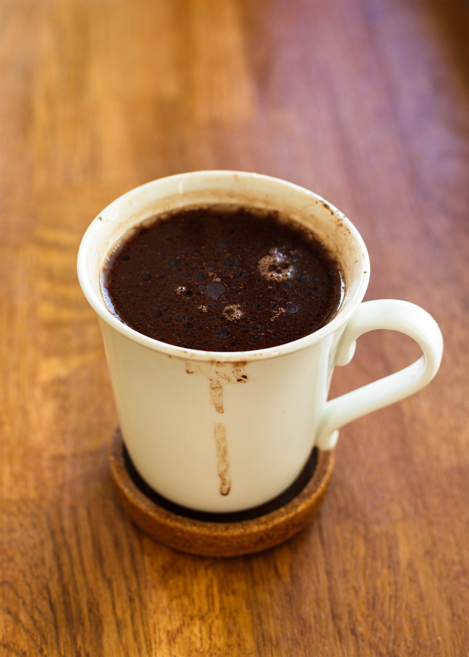Mug with freshly made 5-Minute Vegan Hot Cocoa on a wooden table