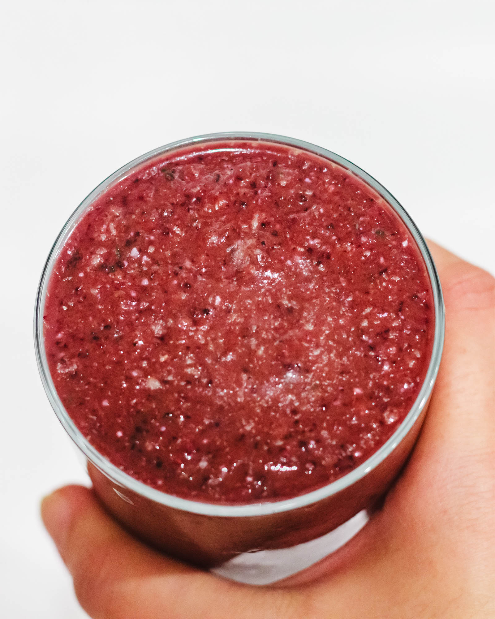 Close-up with a glass of Cold Busting Smoothie held in hand