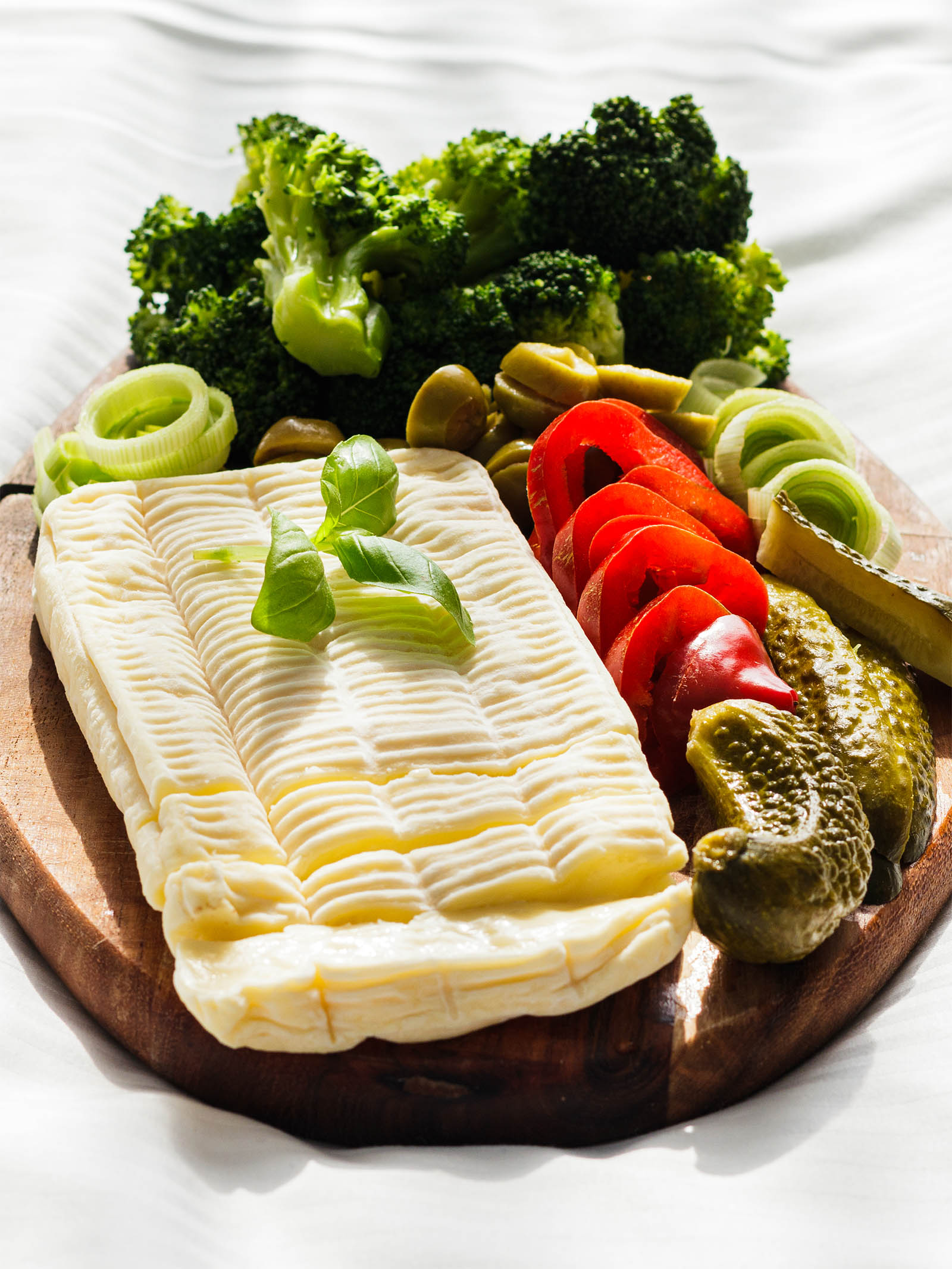 Vegetarian French Platter: La Brique and Vegetables presented on a white background, front view