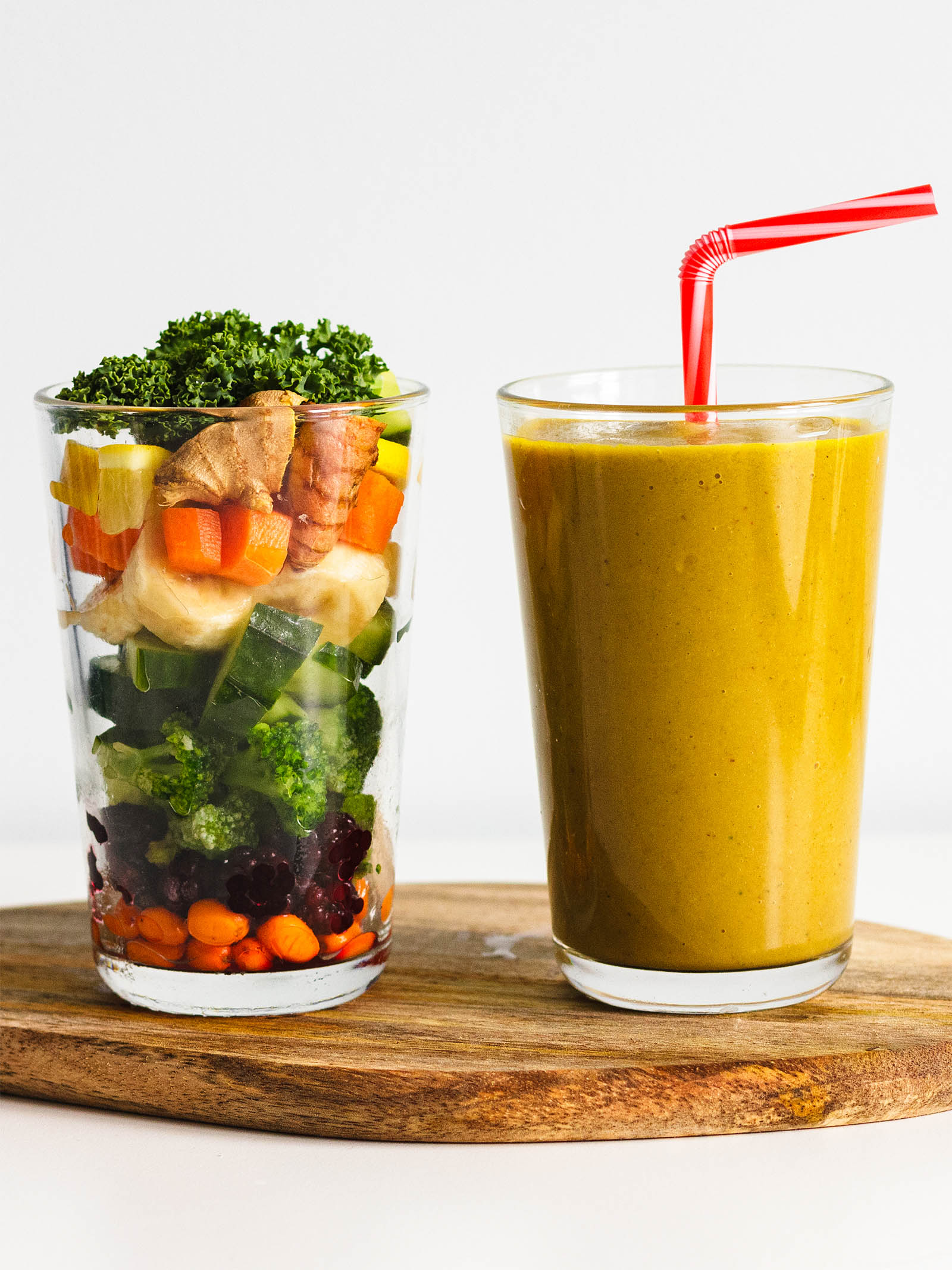 Big glass of Sweet Love Vegetable Smoothie, and another glass with vegetable ingredients used for blending this smoothie